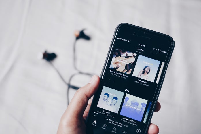 hand holding iphone showing spotify