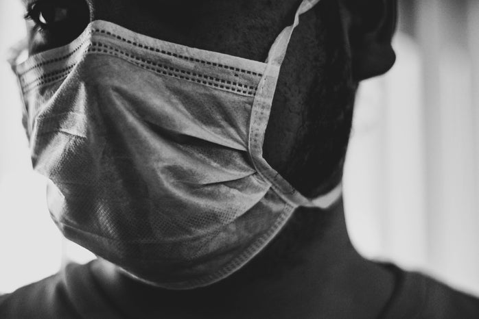 black and white photo of person wearing mask