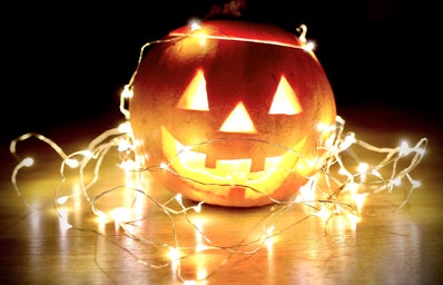 string lights wrapped around pumpkin