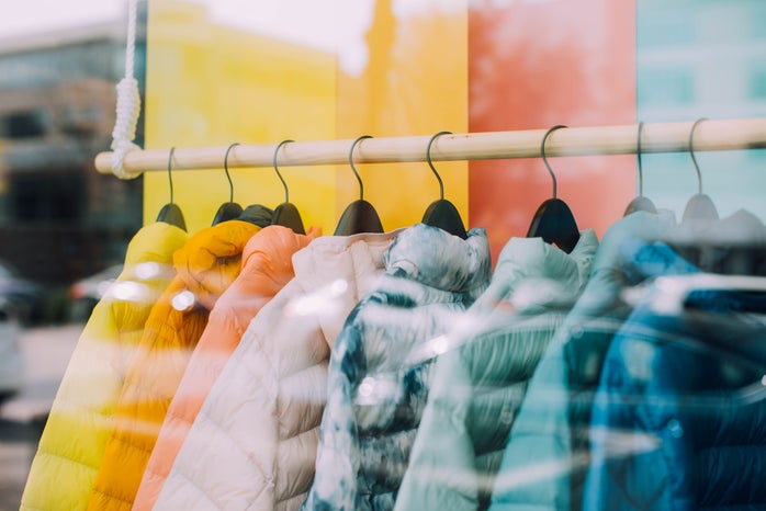 colorful puffer jackets on hangers