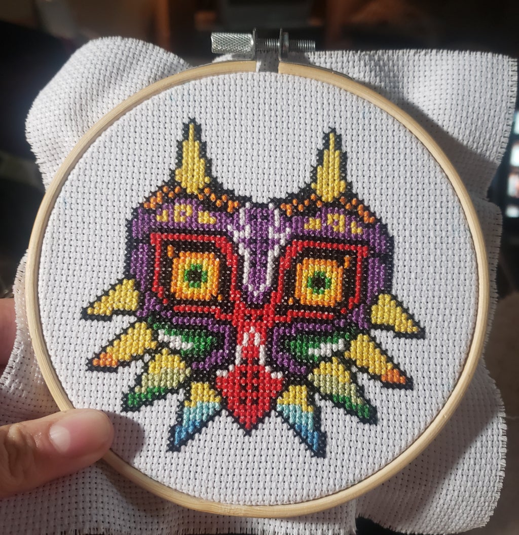 A cross stitch of Majora\'s Mask from the Legend of Zelda Series