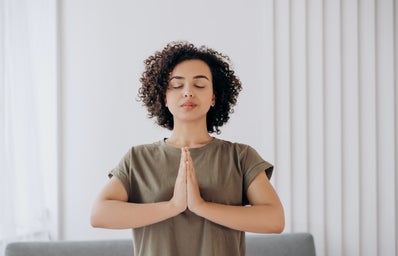 Woman meditates with her eyes closed