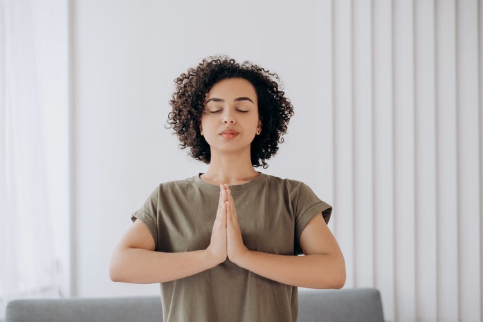 Woman meditates with her eyes closed