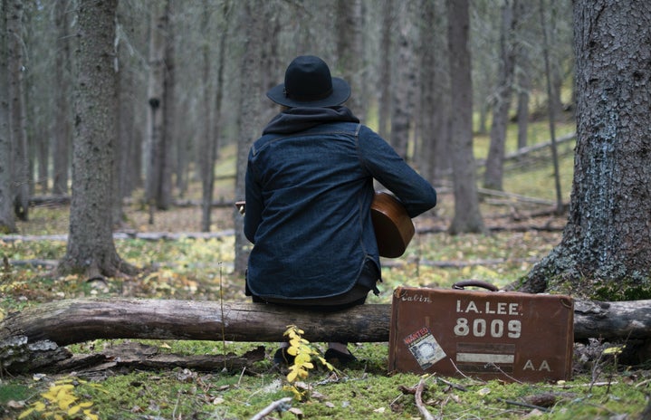 guitar player in the woods