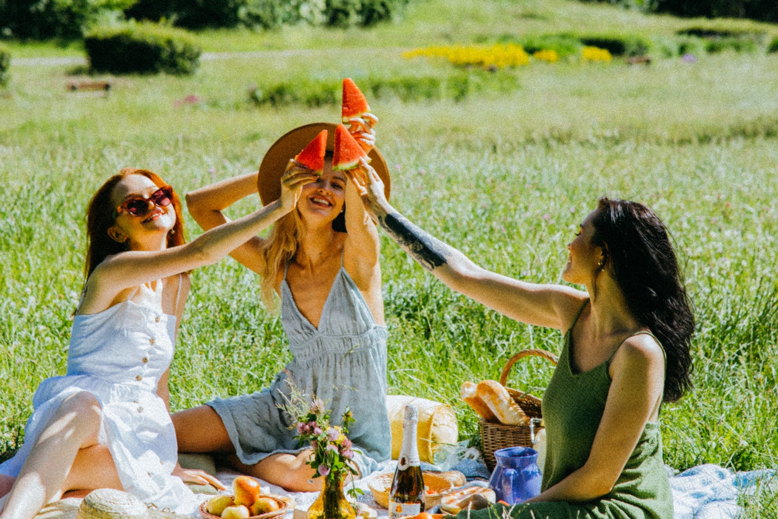 Women having a watermelon picnic.