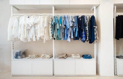 A big closet full of white and blue clothing.