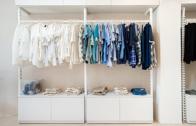 A big closet full of white and blue clothing.