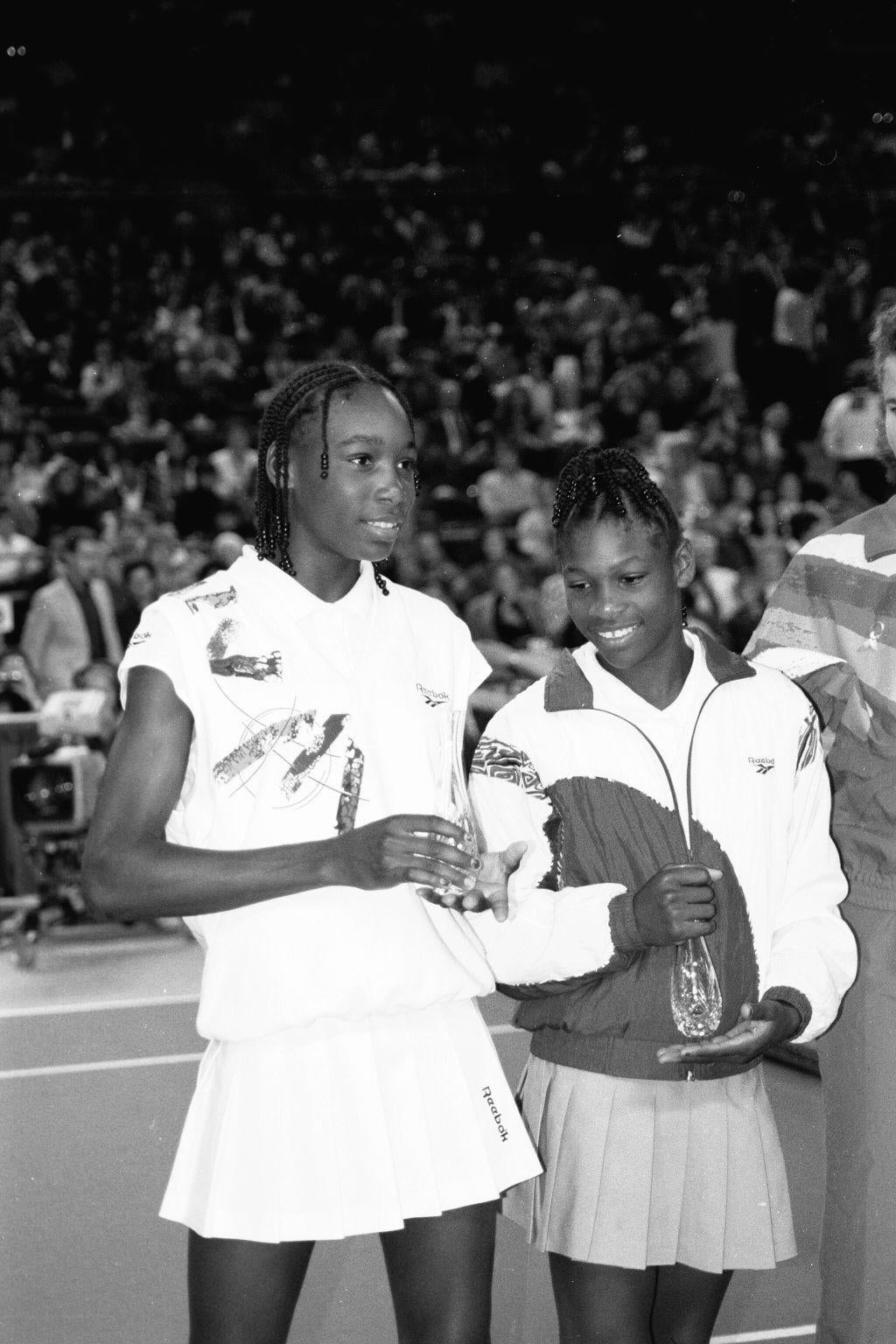 young venus and serena williams winning a tournament