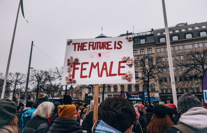 Protester holds "The future is female" sign in Sweden