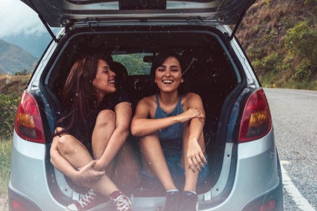 Picture of two friends in back of car