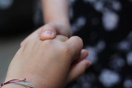 Two women holding hands