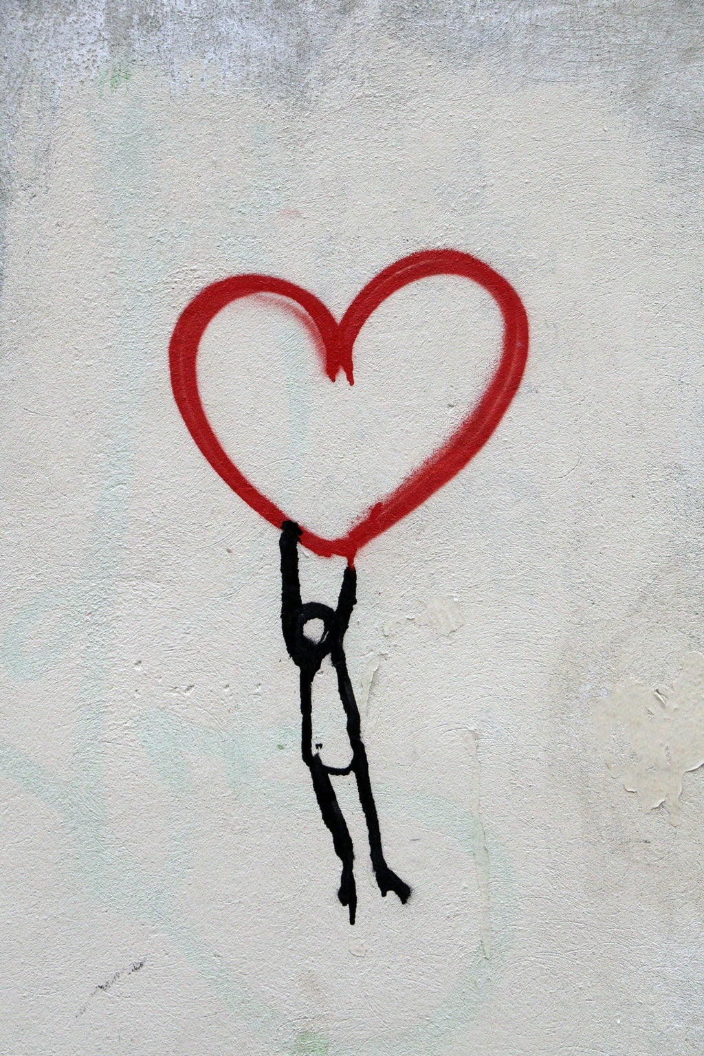 Stick figure drawing holding onto heart