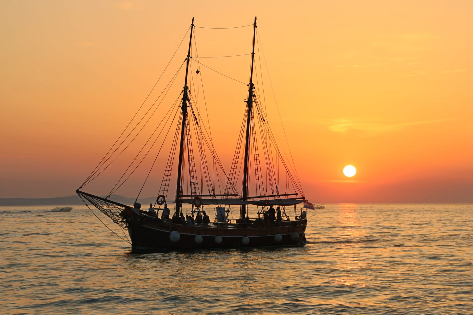 boat in front of a sunset