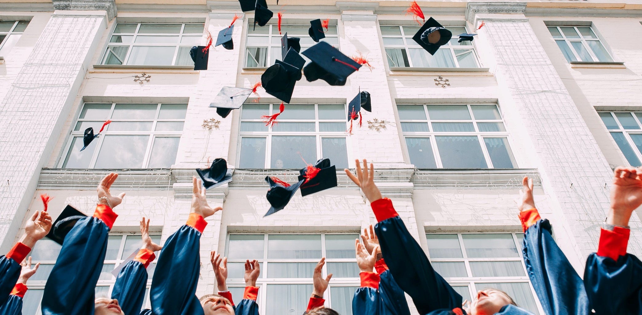 graduation caps thrown in air