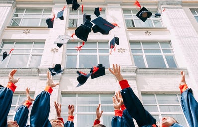 graduation caps thrown in air