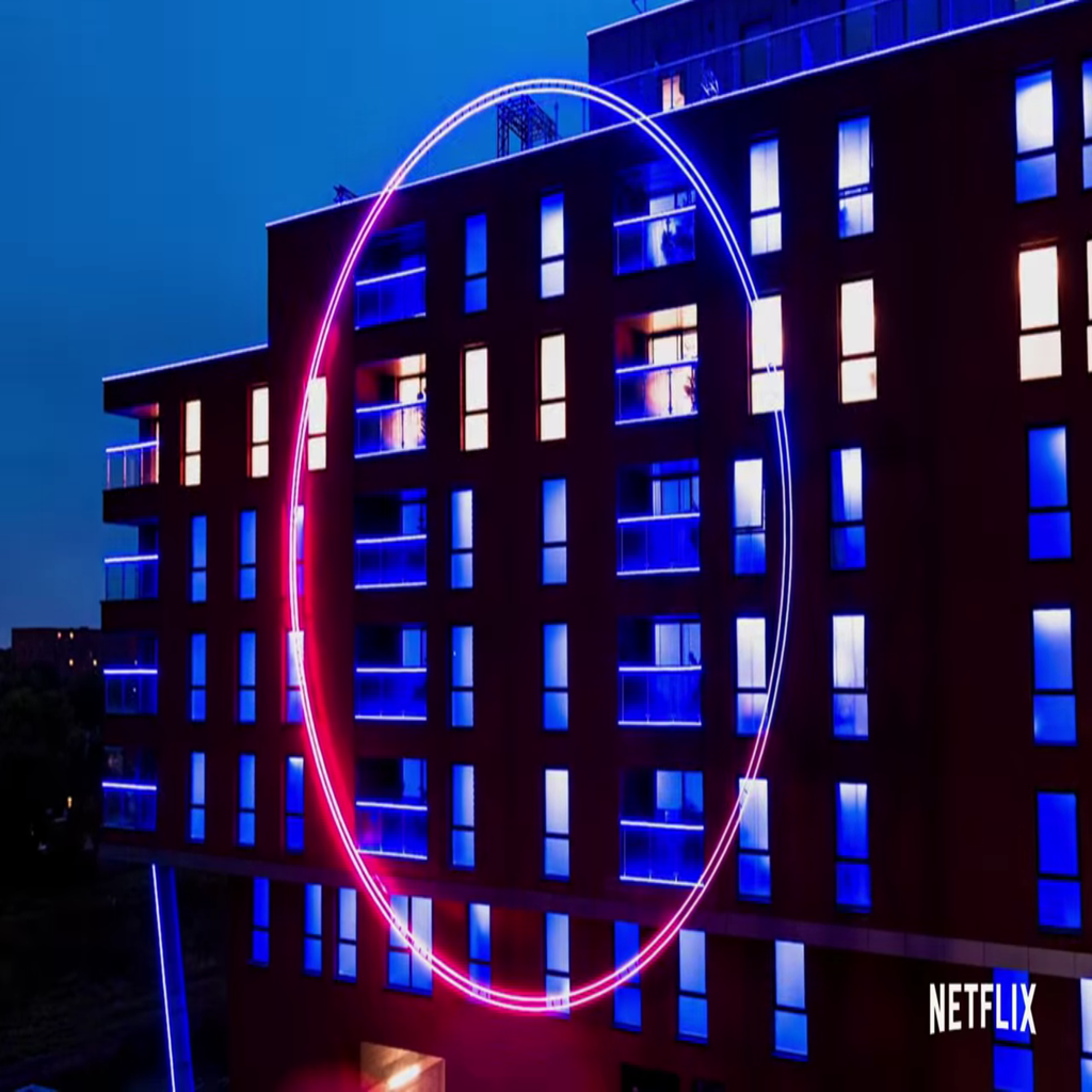 Large glowing circle on the outside of a building from The Circle Official Trailer on YouTube by Netflix