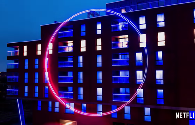 Large glowing circle on the outside of a building from The Circle Official Trailer on YouTube by Netflix
