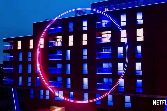 Large glowing circle on the outside of a building from The Circle Official Trailer on YouTube by Netflix