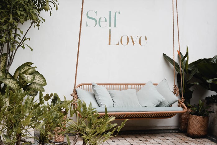 Self love, with plants and hanging bench background