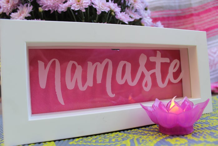 Namaste sign with pink background