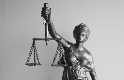 black and white photo of Lady Justice holding the scales of justice
