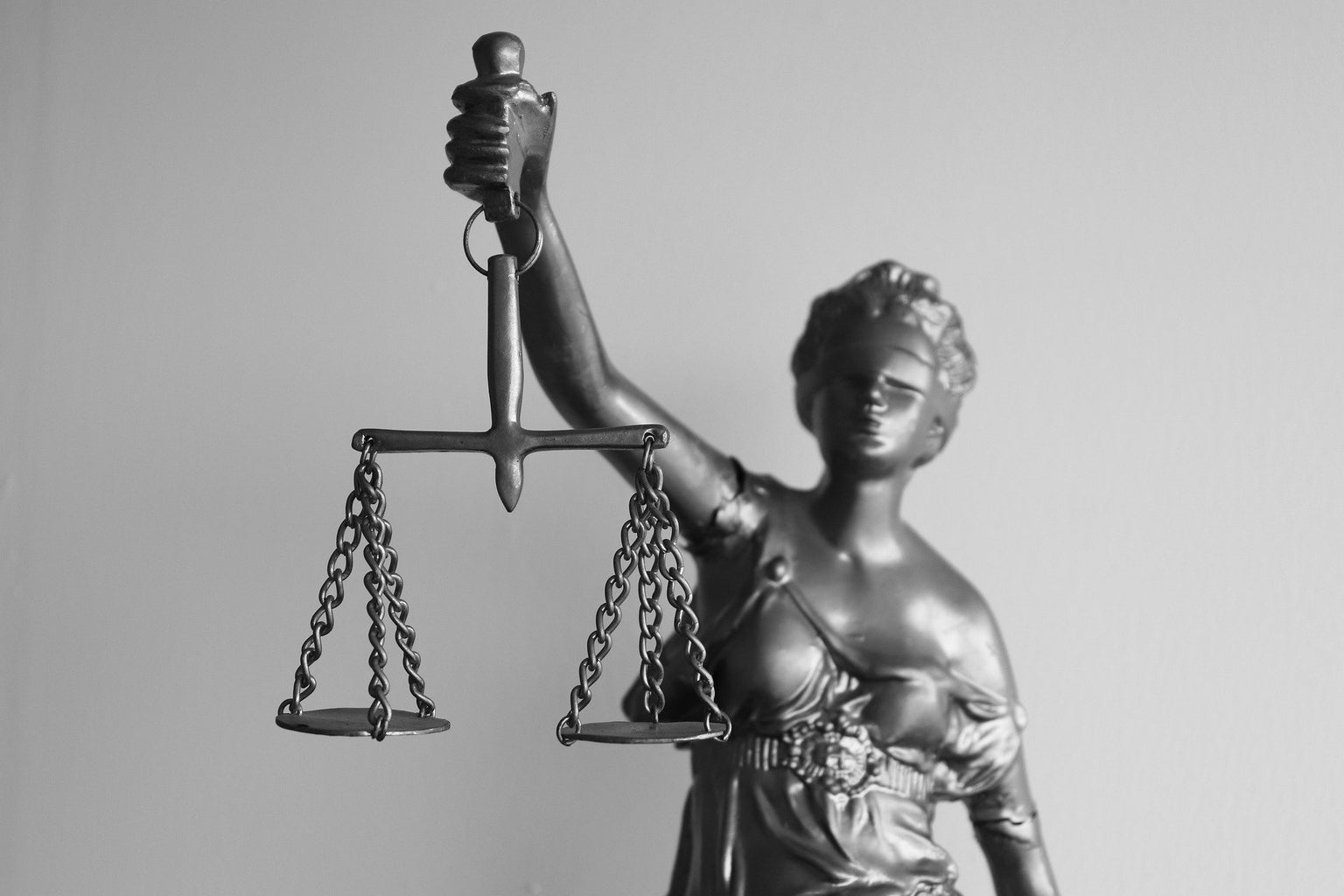 black and white photo of Lady Justice holding the scales of justice