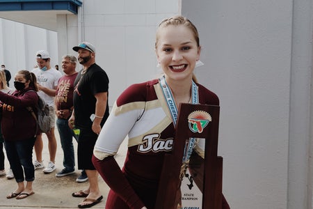 cheerleader holding trophy