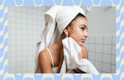 young person drying face with towel