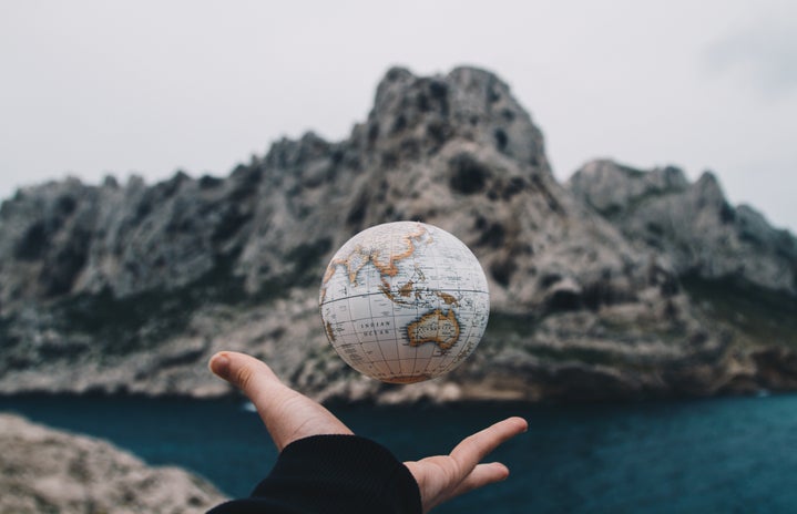 person holding small globe by Valentin Antonucci?width=719&height=464&fit=crop&auto=webp