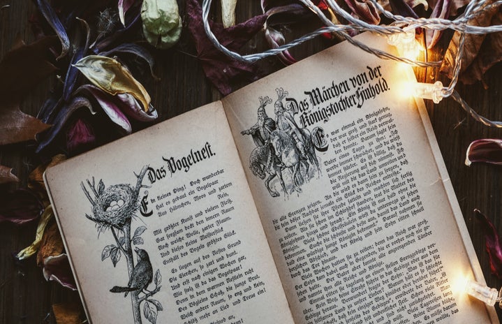 A fairy tale book in German, surrounded by flowers