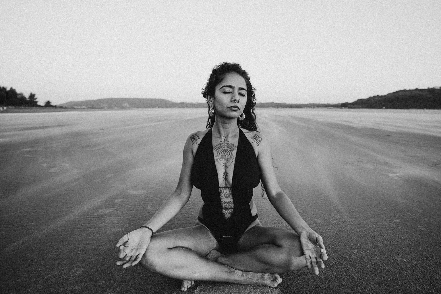 woman in black swimsuit meditating