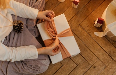 person wrapping gift