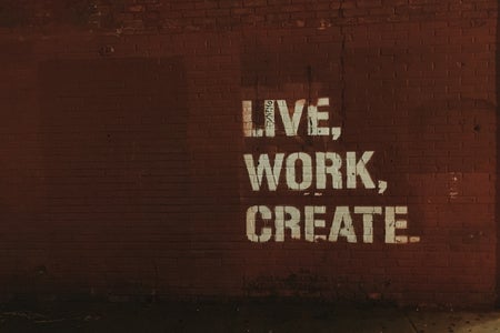 red brick wall with live, work, create