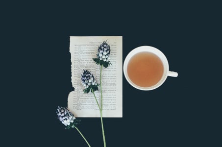 teacup with flower and book page