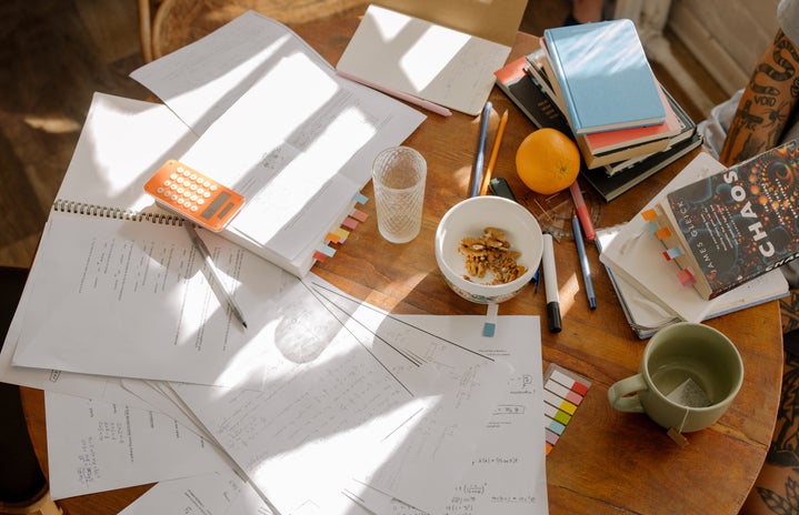 study notes and books on a brown wooden table