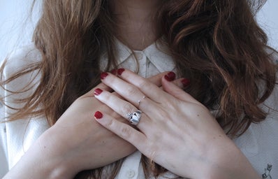 brunette girl with red nail polish and wedding ring