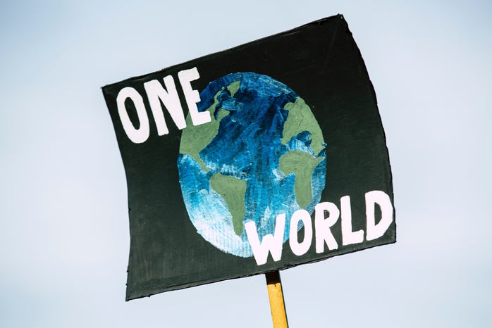 sign that has the earth on it that says "one world"