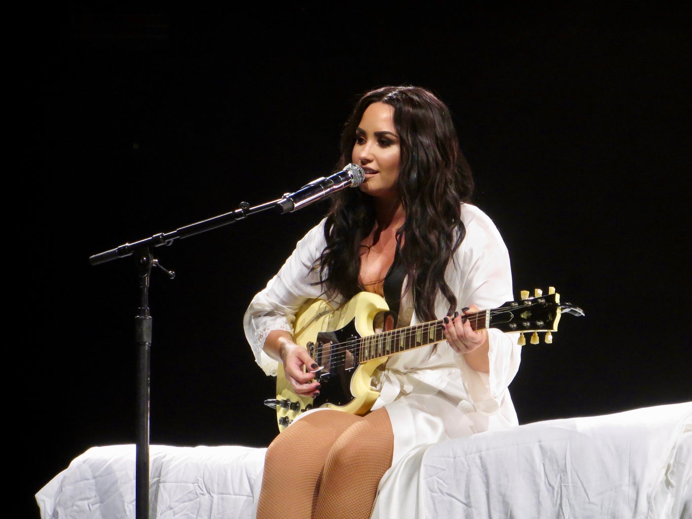 demi lovato playing guitar on stage