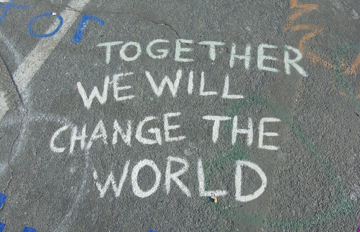 Chalk art that says \"together we will change the world\"