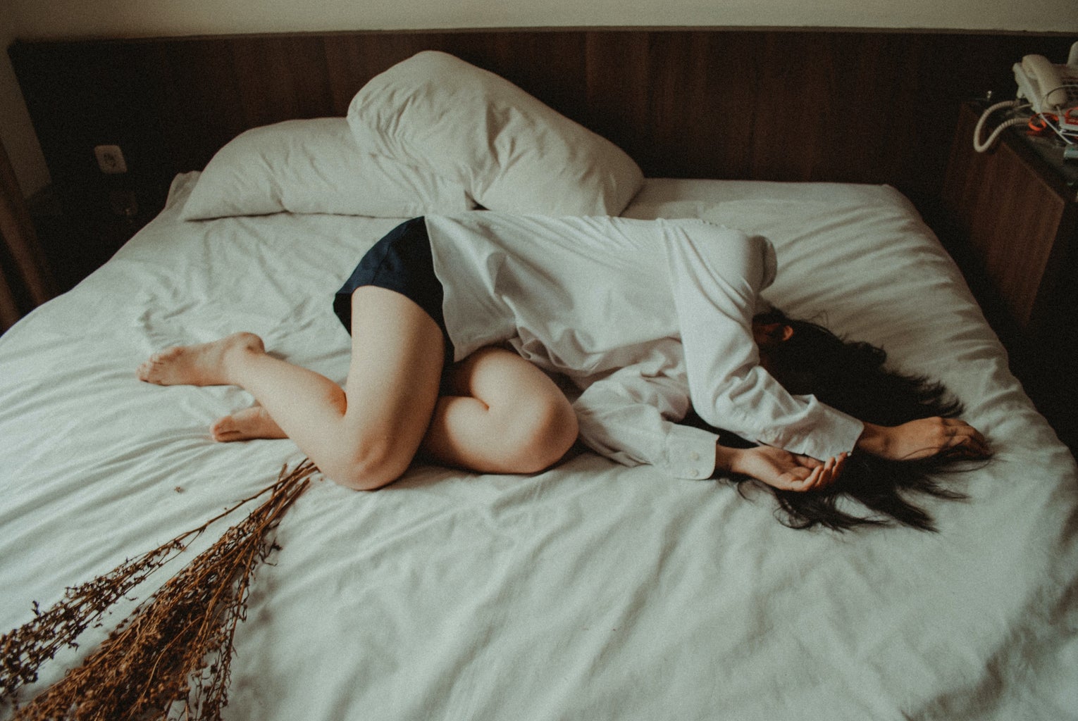 woman lying in white bed