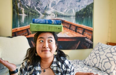Woman with books balanced on her head