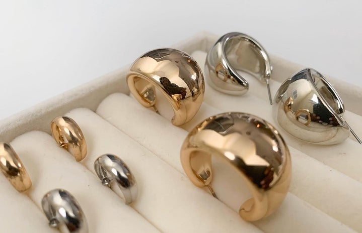 Gold and silver earrings in a jewelry organizer