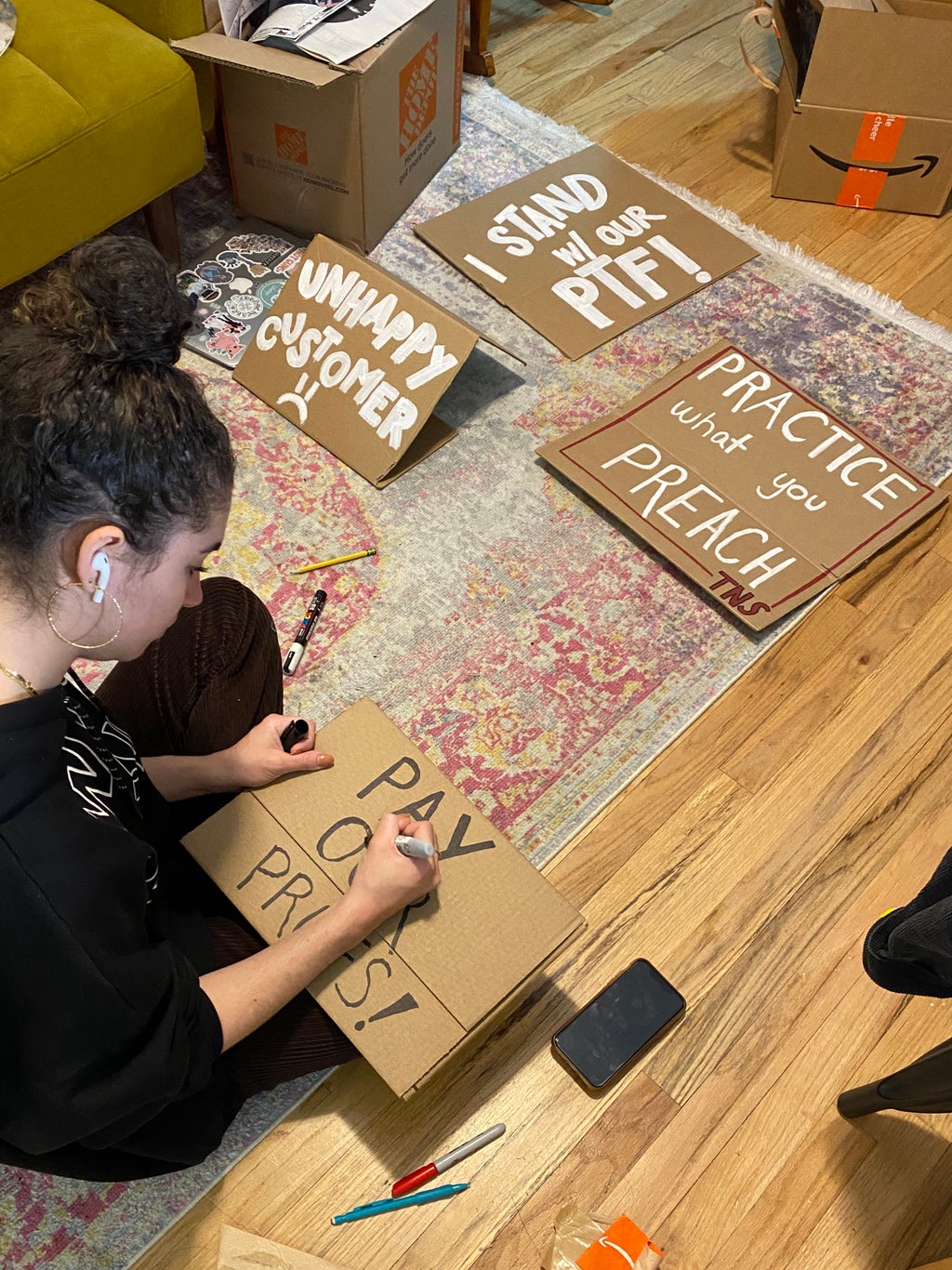 Isabelle Bouvier sitting at home making cardboard signs for a strike.