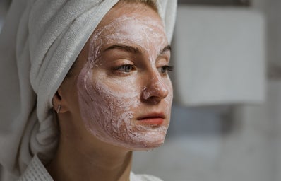 woman with white towel on head and face mask
