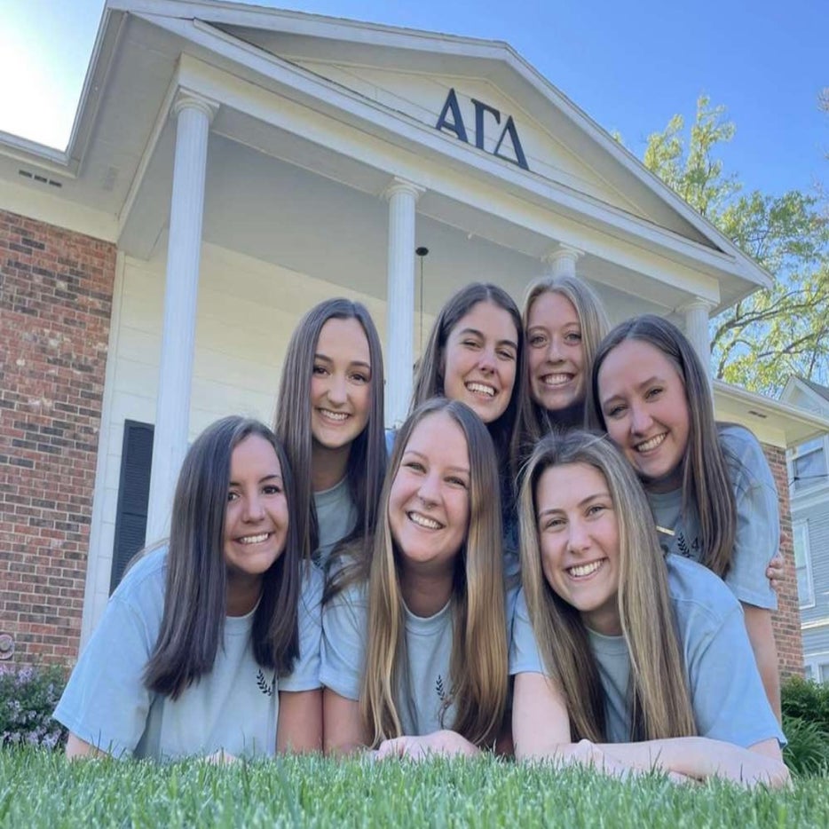 Sorority women in front of their house