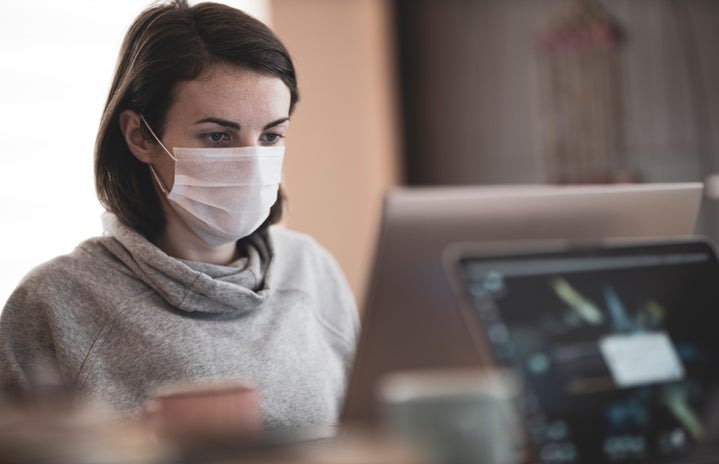 woman looking at a computer while wearing a mask by engin akyurt on Unsplash?width=719&height=464&fit=crop&auto=webp