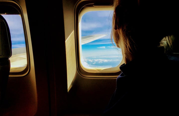 Person looking outside of an airplane