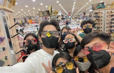 Selfie of people wearing wacky sunglasses.