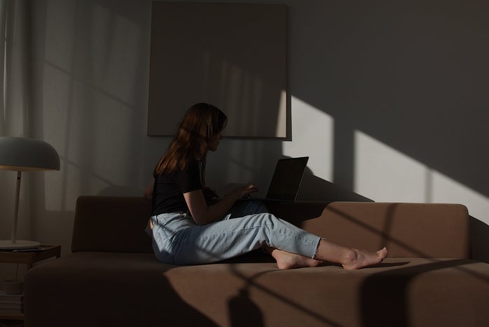 woman sitting on her laptop
