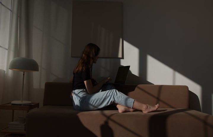 woman sitting on her laptop